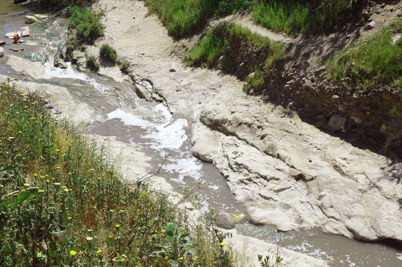 Erosion to bedrock downstream of a sediment-retention basin, Tijuana, Baja California, Mexico.