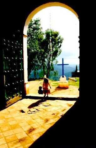 Local girl at entrance to 300-yr old 
church at Santiago Tlazoyaltepec