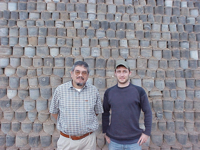 Dr. Victor M. Ponce and Andreas Koch posing in front of retaining wall built with discarded tires. 