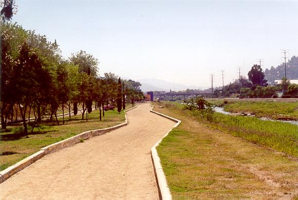 View of the Atoyac river looking downstream to the bridge at project end, <br>showing the walking track on the flood plain