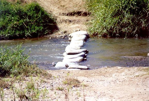 Make-shift bridge made out of sand bags